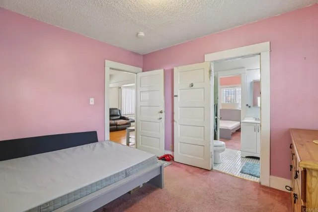 a bedroom with pink walls