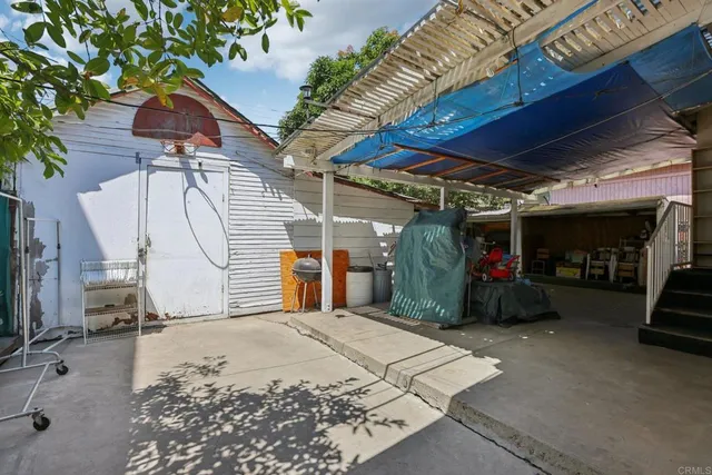 a view of a backyard with a patio and a tub