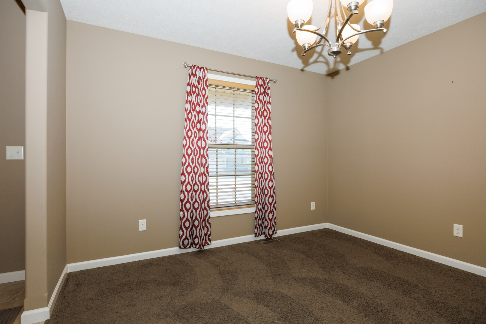 1714 Flagstone Drive Normal, IL 61761 - Photo 11 of 61 an empty room with windows and chandelier fan