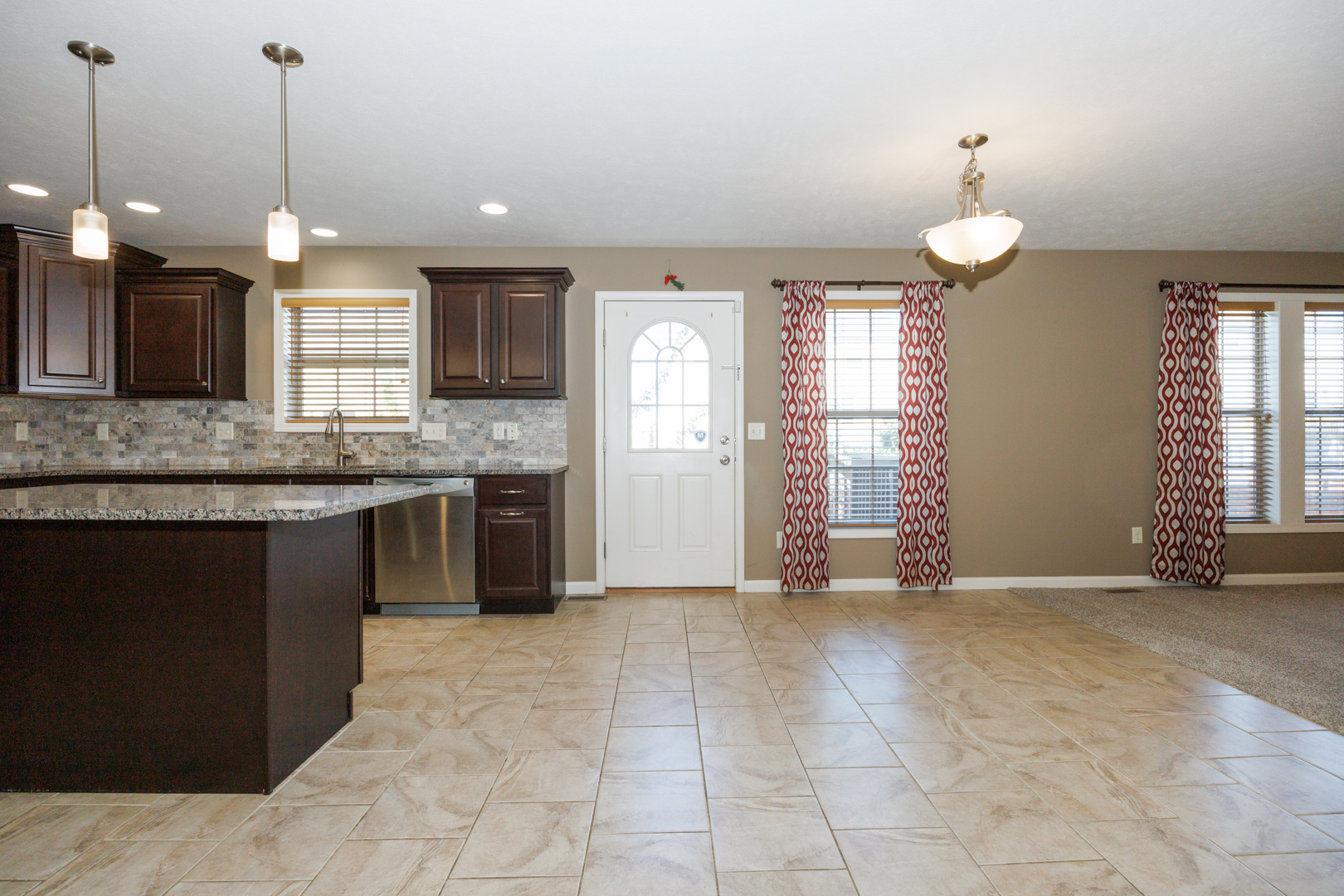 1714 Flagstone Drive Normal, IL 61761 - Photo 14 of 61 a view of a kitchen with a sink and chandelier