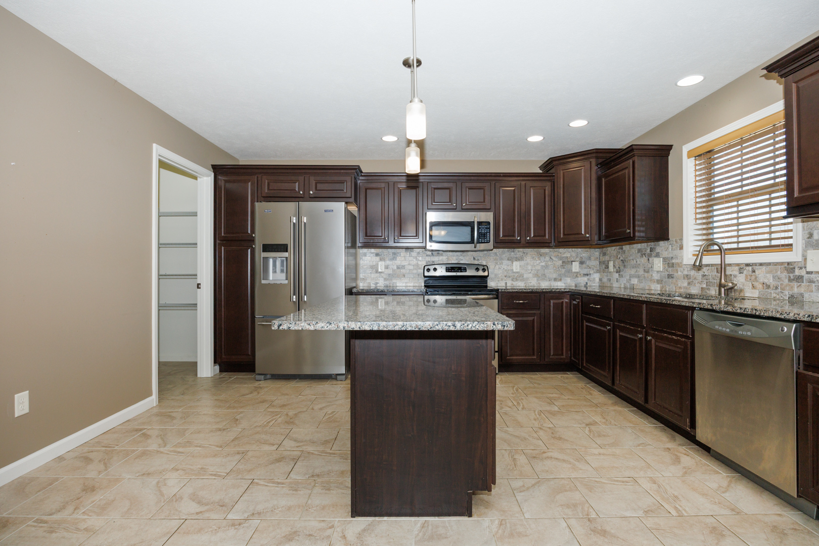 1714 Flagstone Drive Normal, IL 61761 - Photo 21 of 61 a kitchen with stainless steel appliances granite countertop a refrigerator a stove a sink a microwave and island