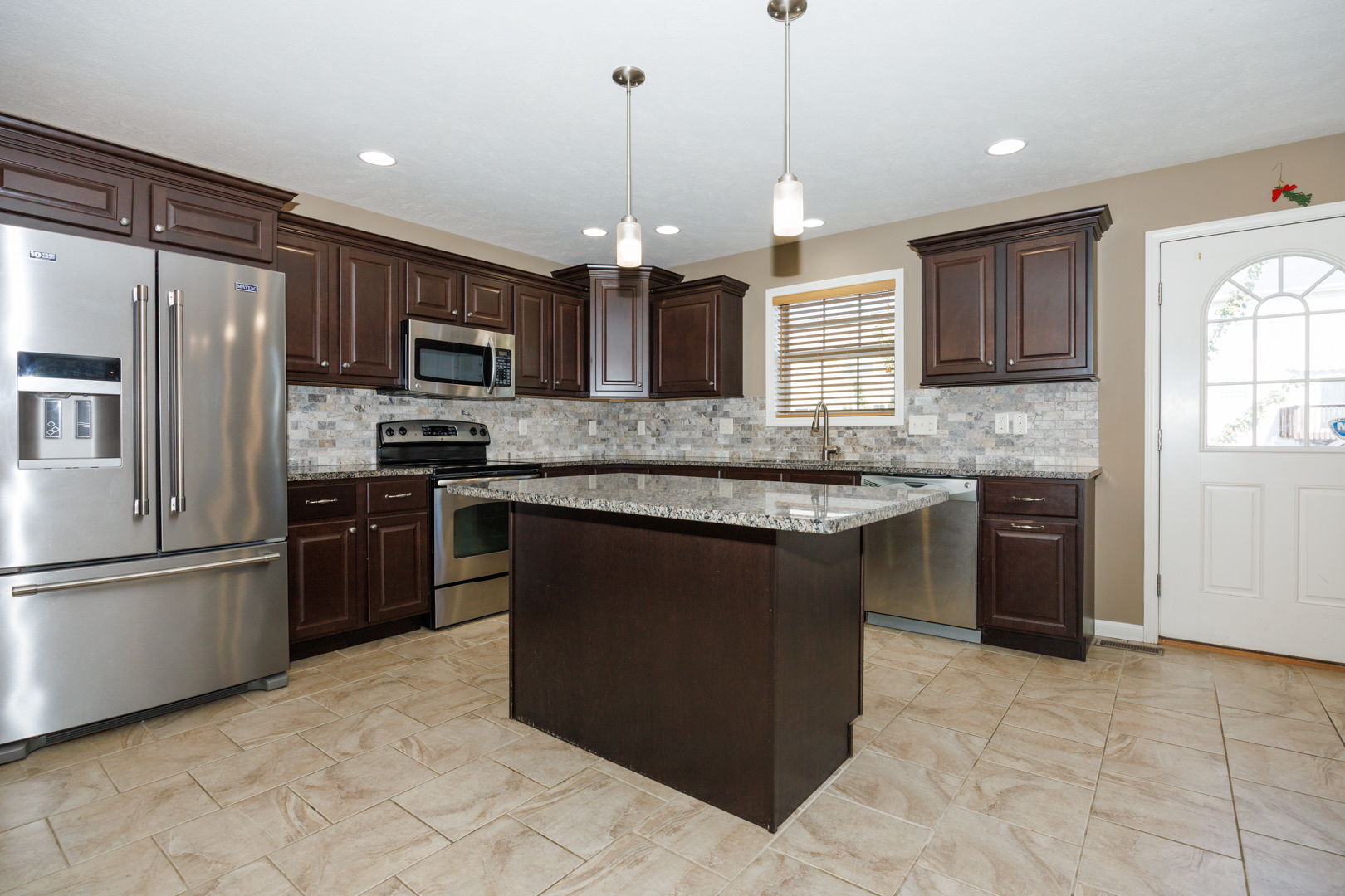 1714 Flagstone Drive Normal, IL 61761 - Photo 22 of 61 a kitchen with stainless steel appliances granite countertop a sink a stove a refrigerator and a microwave