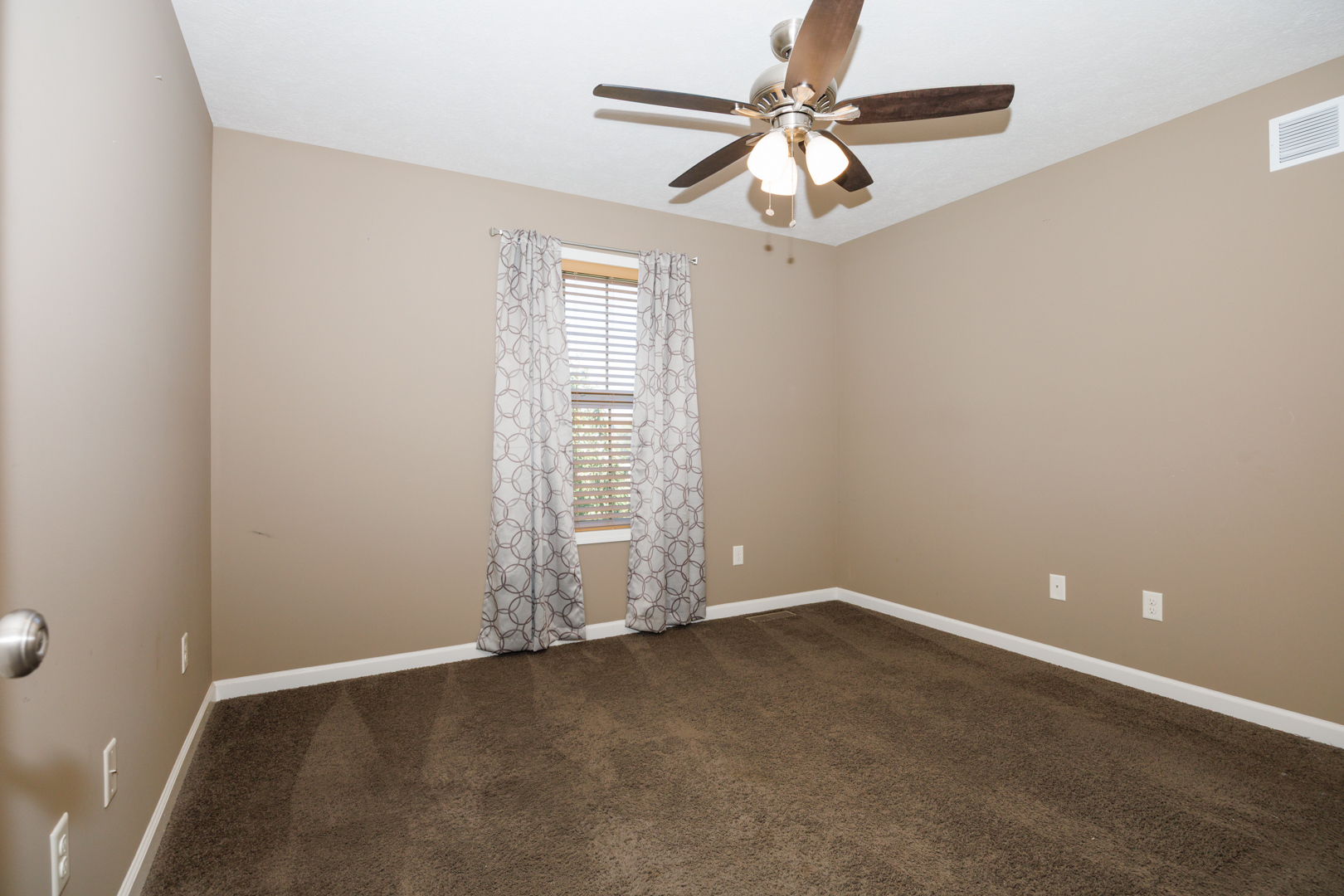 1714 Flagstone Drive Normal, IL 61761 - Photo 34 of 61 an empty room with a chandelier fan and windows