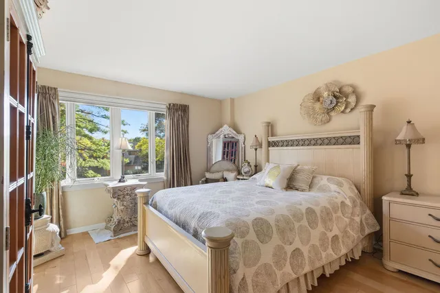 a bedroom with a large bed and a window