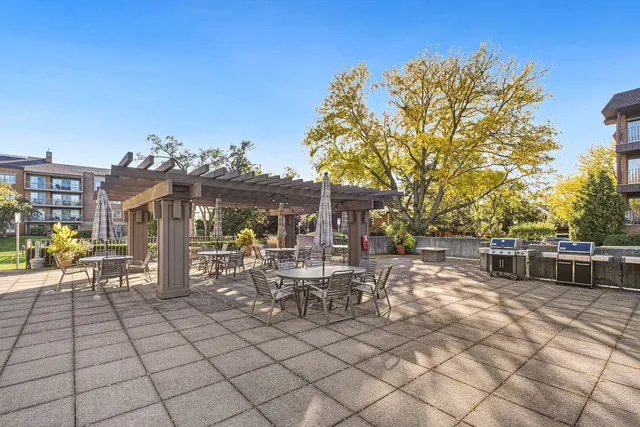 a view of a patio with dining table and chairs with wooden fence