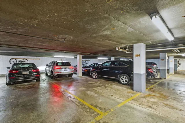 a view of parking garage with cars parked