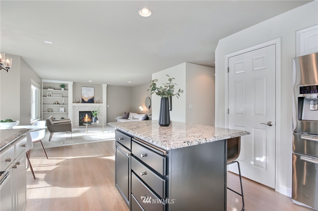 4405 Northeast 7th Street Renton, WA 98059 - Photo 12 of 27 a kitchen with stainless steel appliances granite countertop a sink and a refrigerator