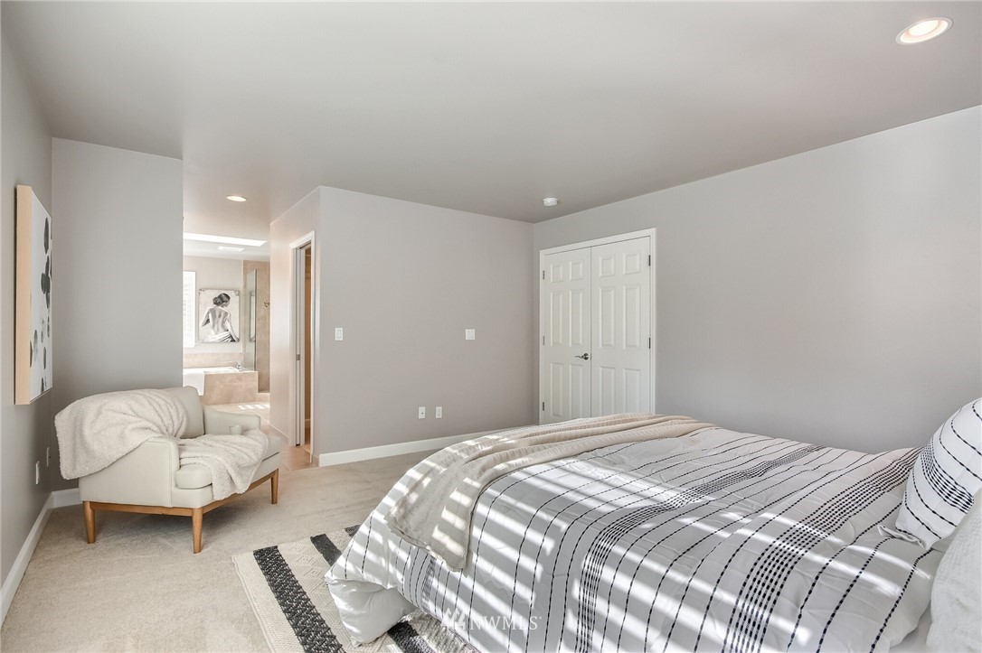 4405 Northeast 7th Street Renton, WA 98059 - Photo 19 of 27 a bedroom with a bed couch and a window