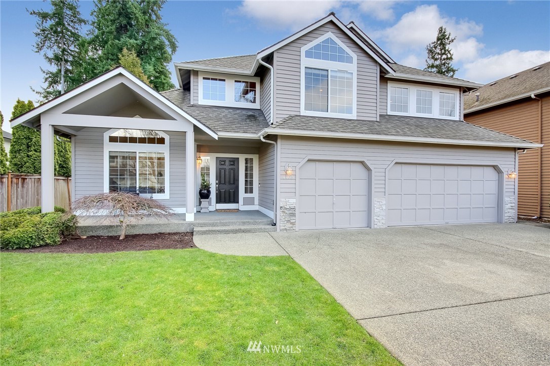 4405 Northeast 7th Street Renton, WA 98059 - Photo 2 of 27 a front view of a house with a yard and garage