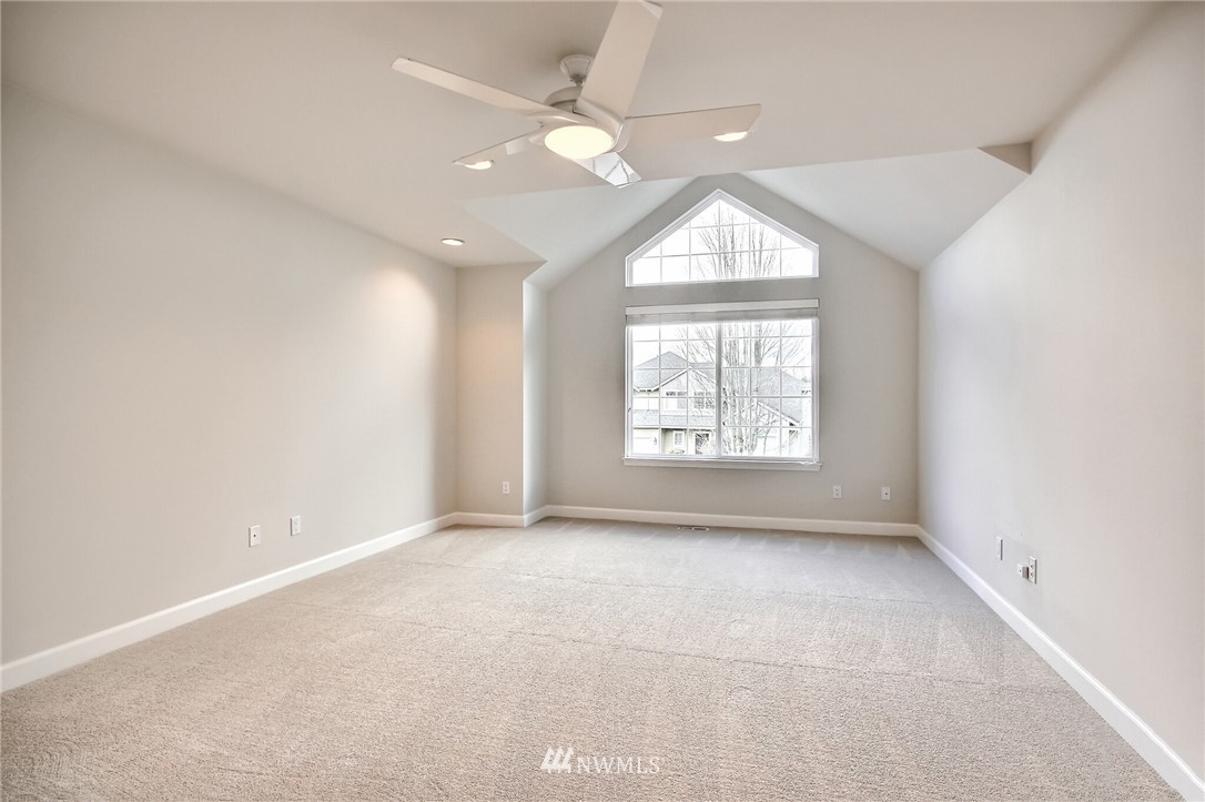 4405 Northeast 7th Street Renton, WA 98059 - Photo 22 of 27 an empty room with a window and a ceiling fan