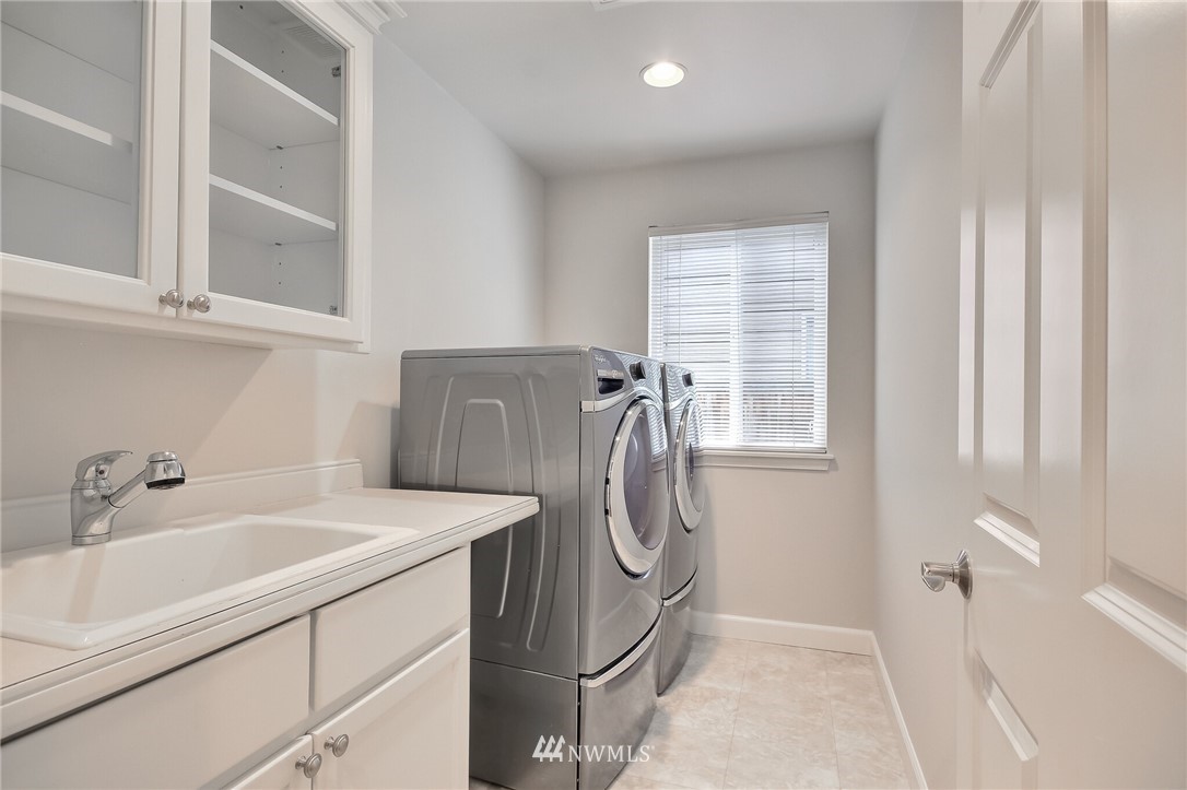 4405 Northeast 7th Street Renton, WA 98059 - Photo 23 of 27 a bathroom with a sink a mirror and a window