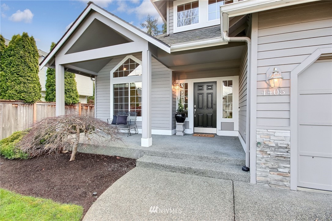 4405 Northeast 7th Street Renton, WA 98059 - Photo 4 of 27 a view of a house with a small yard and sitting area