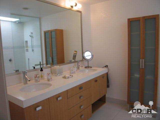 293 Serena Drive Palm Desert, CA 92260 - Photo 12 of 14 a bathroom with a double vanity sink and a mirror