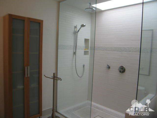 293 Serena Drive Palm Desert, CA 92260 - Photo 13 of 14 a bathroom with a glass shower door