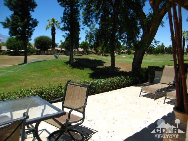 293 Serena Drive Palm Desert, CA 92260 - Photo 2 of 14 a view of a table and chairs in the garden