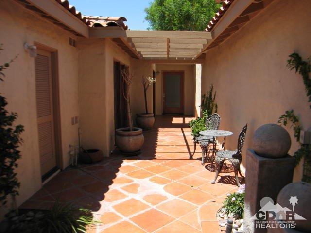 293 Serena Drive Palm Desert, CA 92260 - Photo 3 of 14 a view of a porch with chairs and potted plants