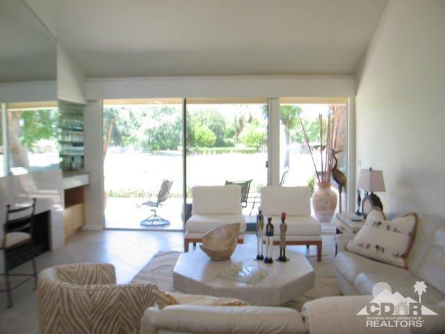 293 Serena Drive Palm Desert, CA 92260 - Photo 5 of 14 a living room with furniture and a large window