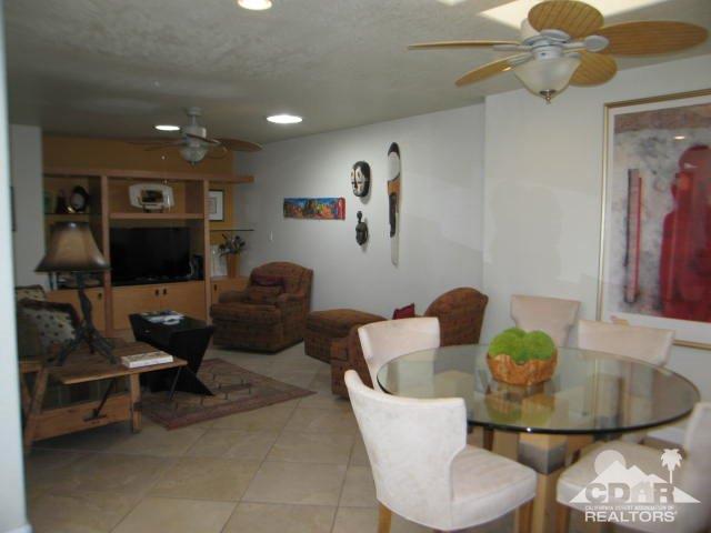 293 Serena Drive Palm Desert, CA 92260 - Photo 9 of 14 a living room with furniture a couch and a chandelier