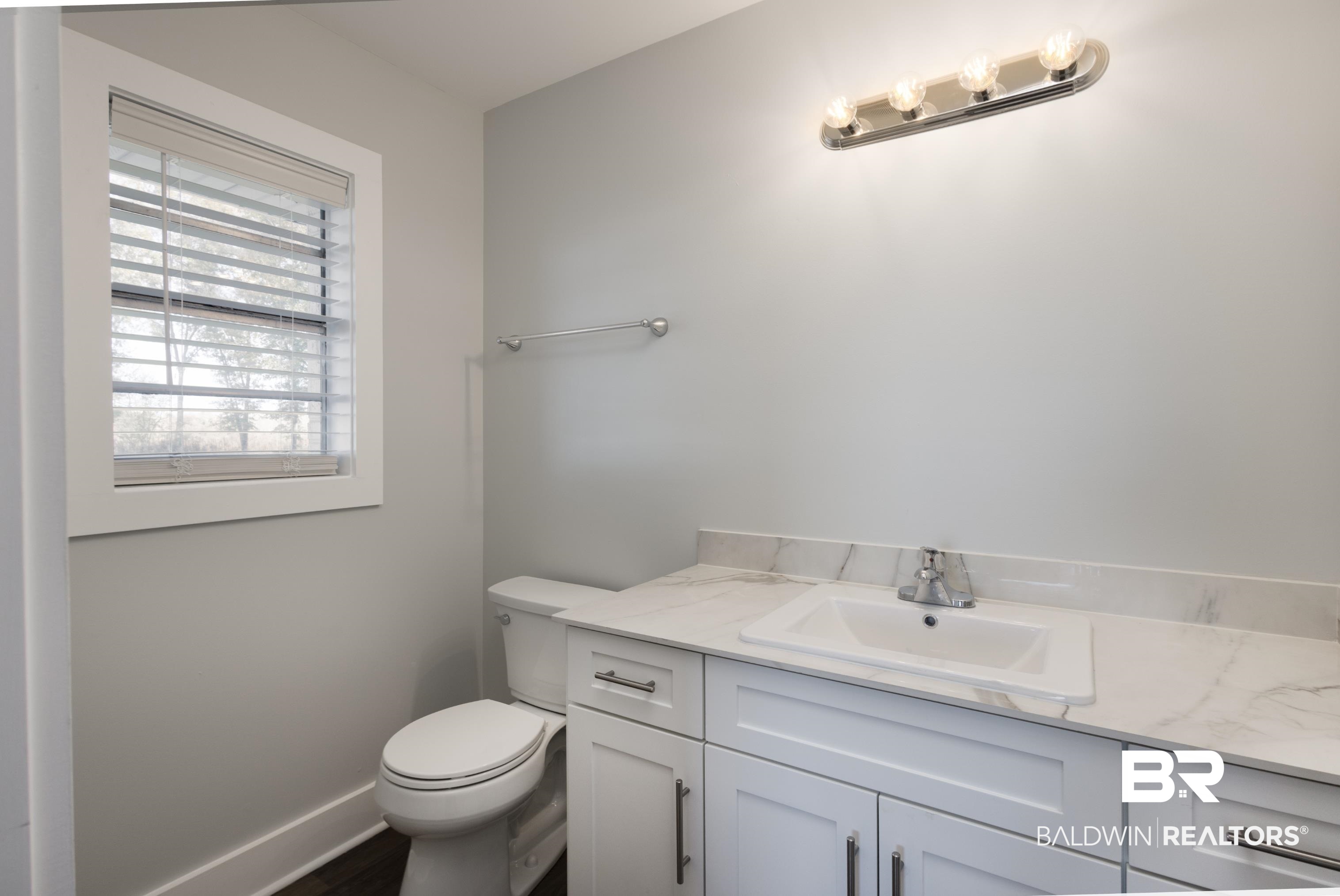 18267 Highway 98 Foley, AL 36535 - Photo 18 of 26 Half bathroom with vanity and toilet