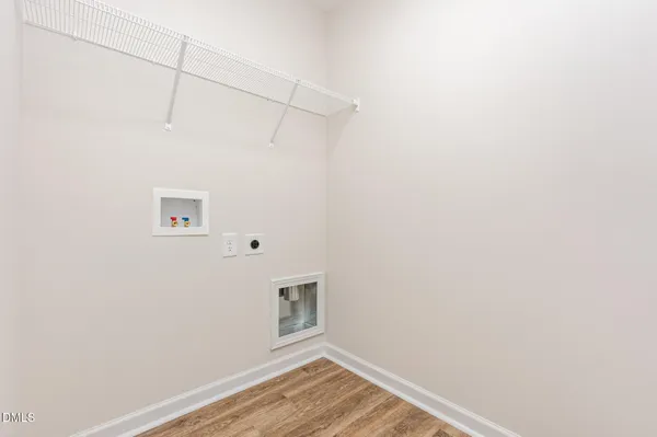 a view of a room with wooden floor