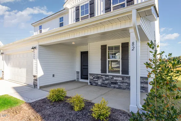 a view of a house with potted plants