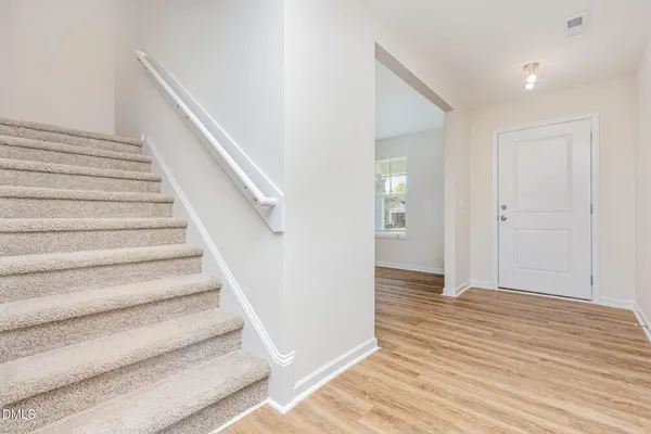 a view of an entryway with wooden floor