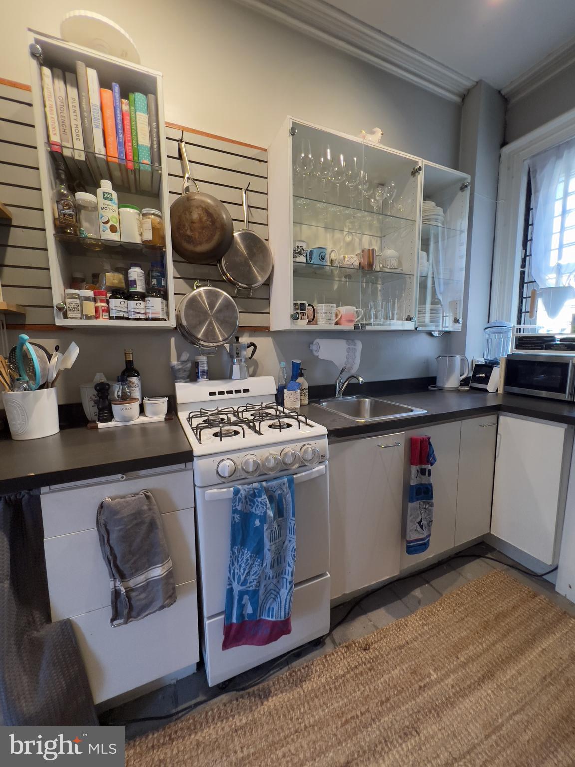 257 South 20th Street, Unit 2F Philadelphia, PA 19103 - Photo 12 of 29 a kitchen with stainless steel appliances granite countertop a stove a sink and a microwave