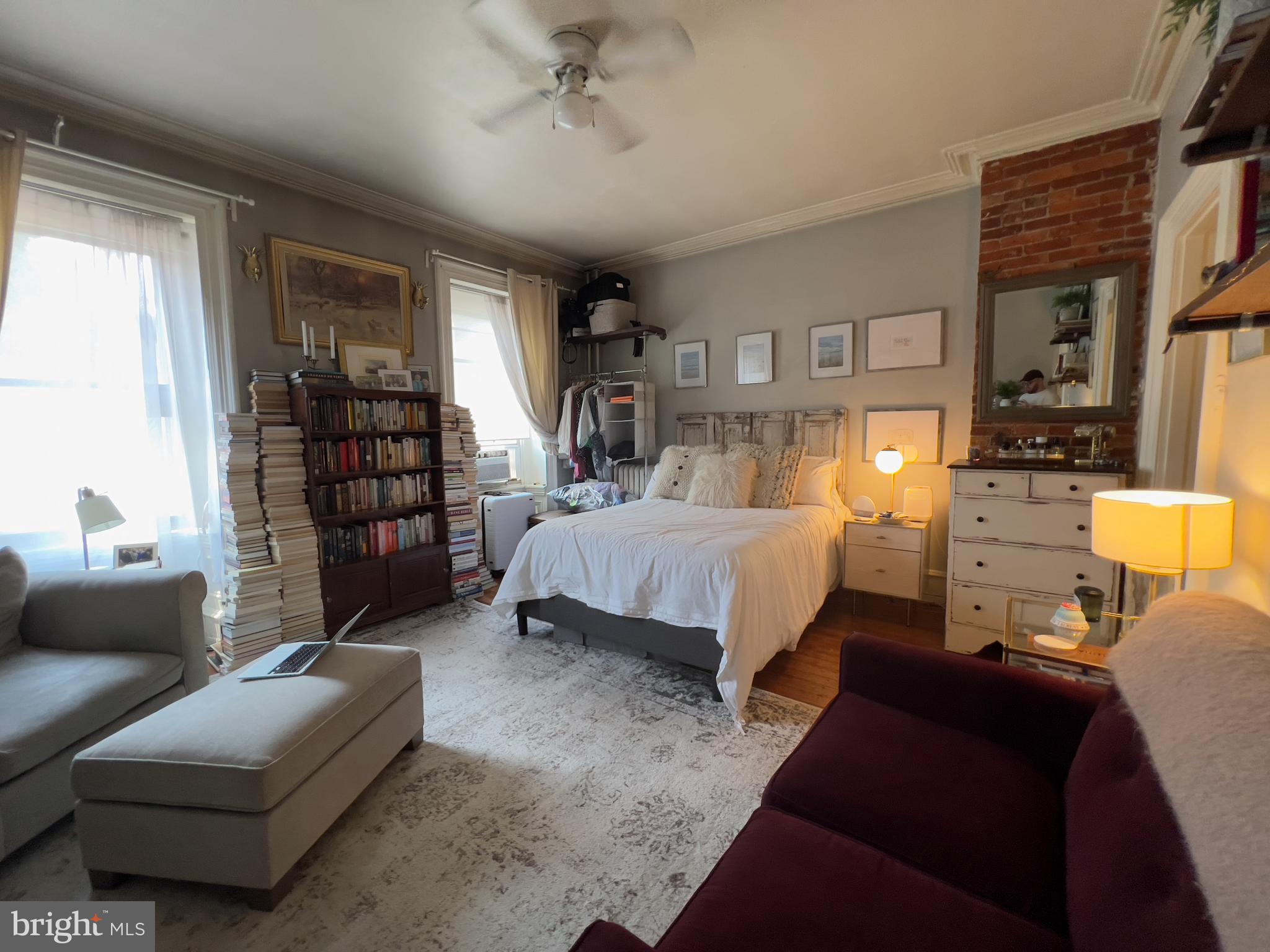 257 South 20th Street, Unit 2F Philadelphia, PA 19103 - Photo 17 of 29 a bedroom with a bed couch and a window