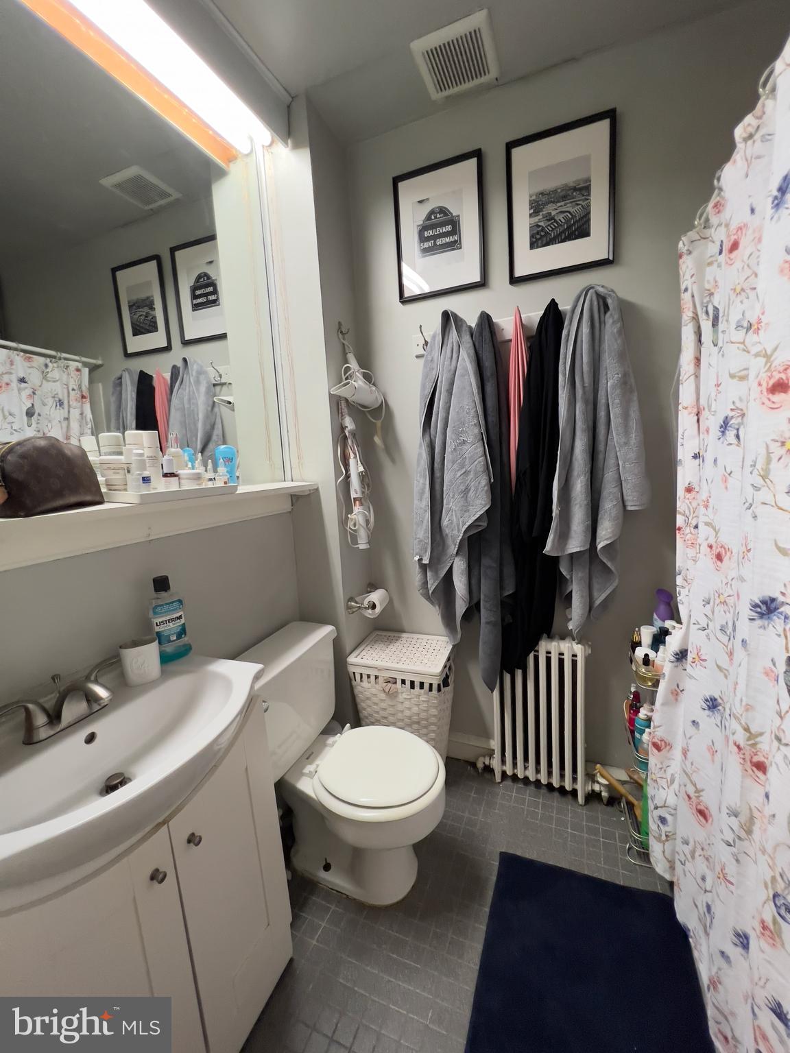 257 South 20th Street, Unit 2F Philadelphia, PA 19103 - Photo 25 of 29 a bathroom with a sink toilet and vanity