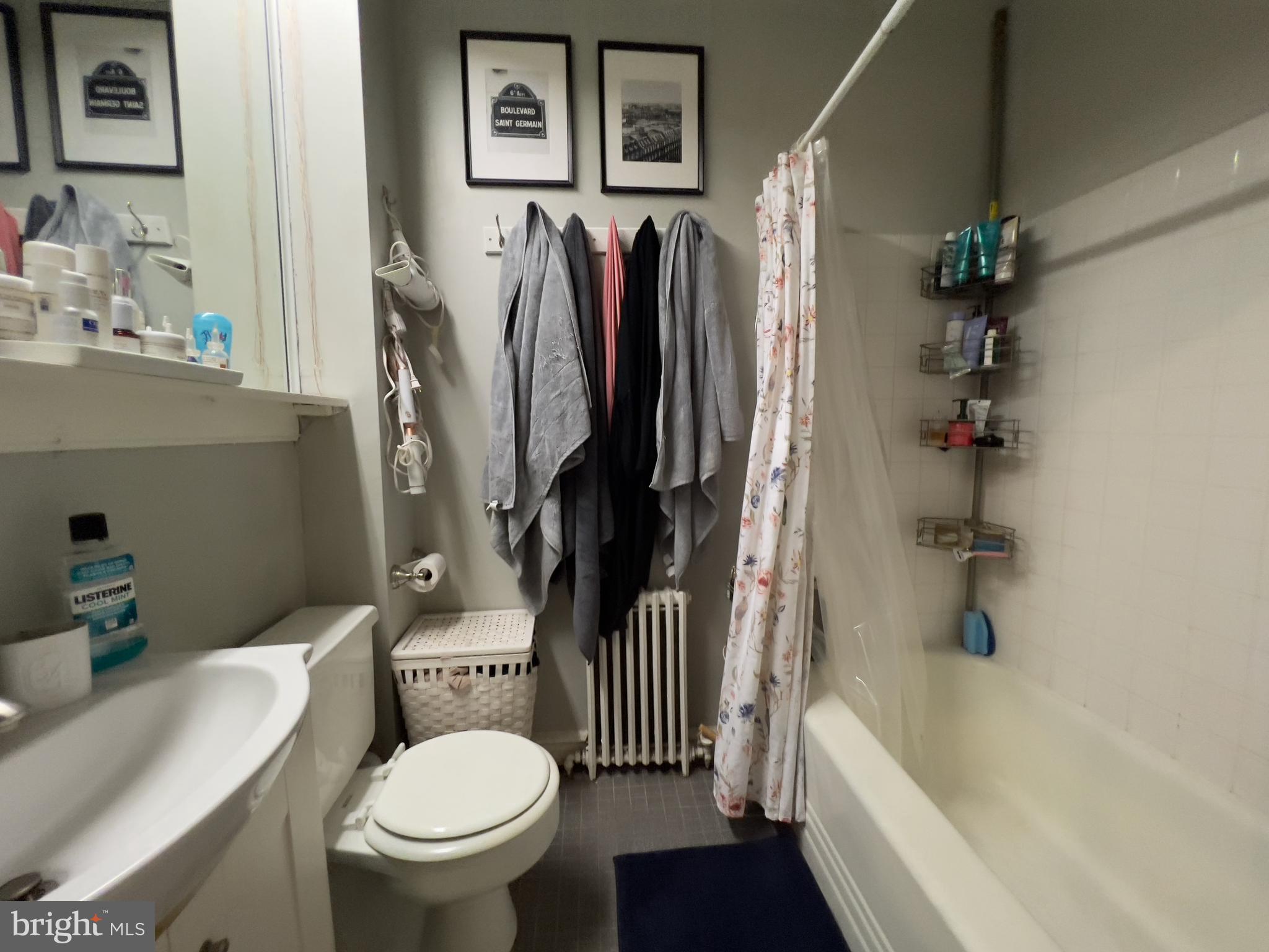 257 South 20th Street, Unit 2F Philadelphia, PA 19103 - Photo 27 of 29 a white toilet sitting next to a bathroom sink and tub