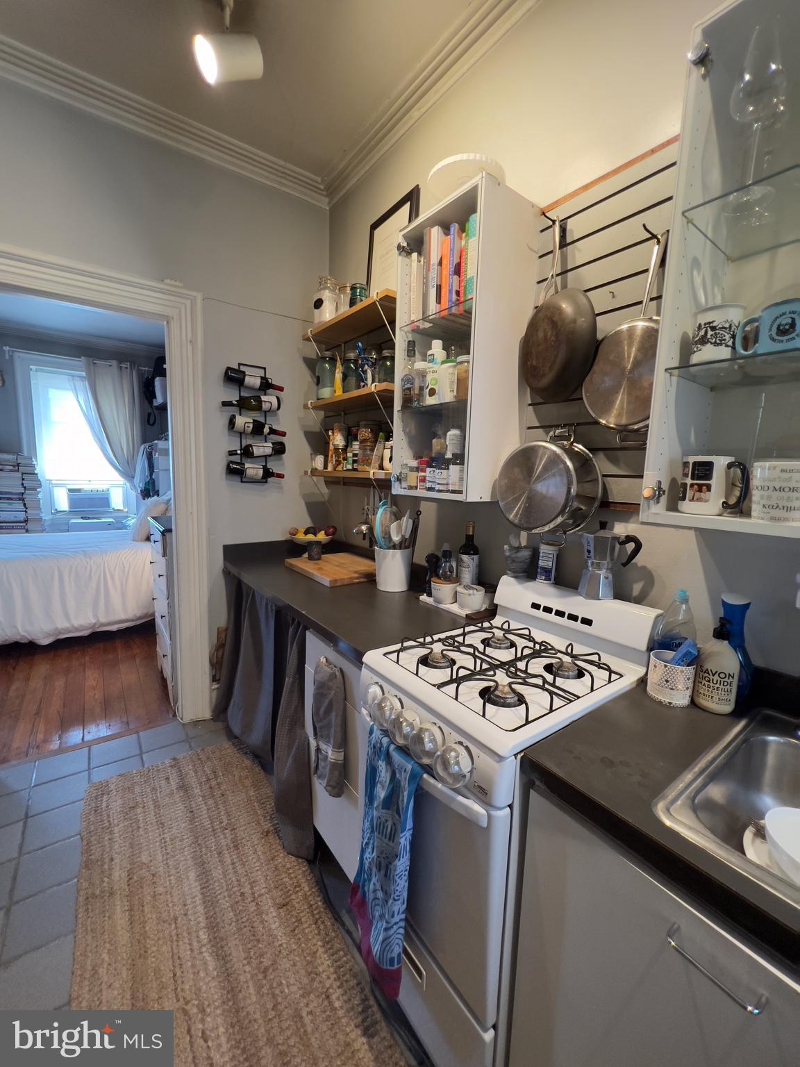 257 South 20th Street, Unit 2F Philadelphia, PA 19103 - Photo 7 of 29 a kitchen with a stove and wooden floor