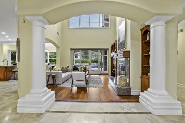 a living room with fireplace furniture and a large window
