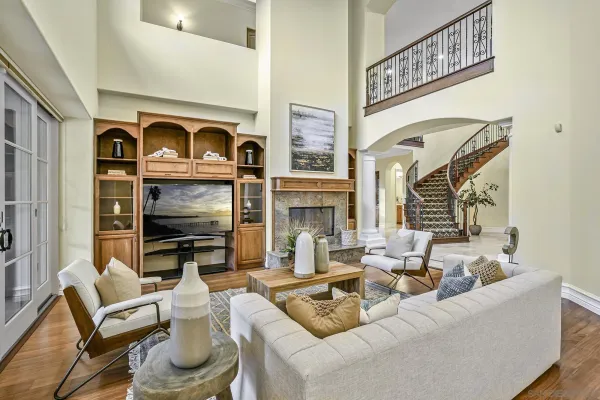 a living room with furniture a fireplace and a flat screen tv
