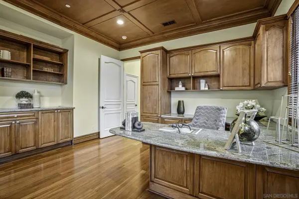 a kitchen with granite countertop a sink a stove and cabinets