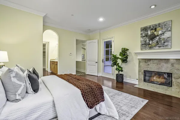 a bedroom with a bed and a fireplace