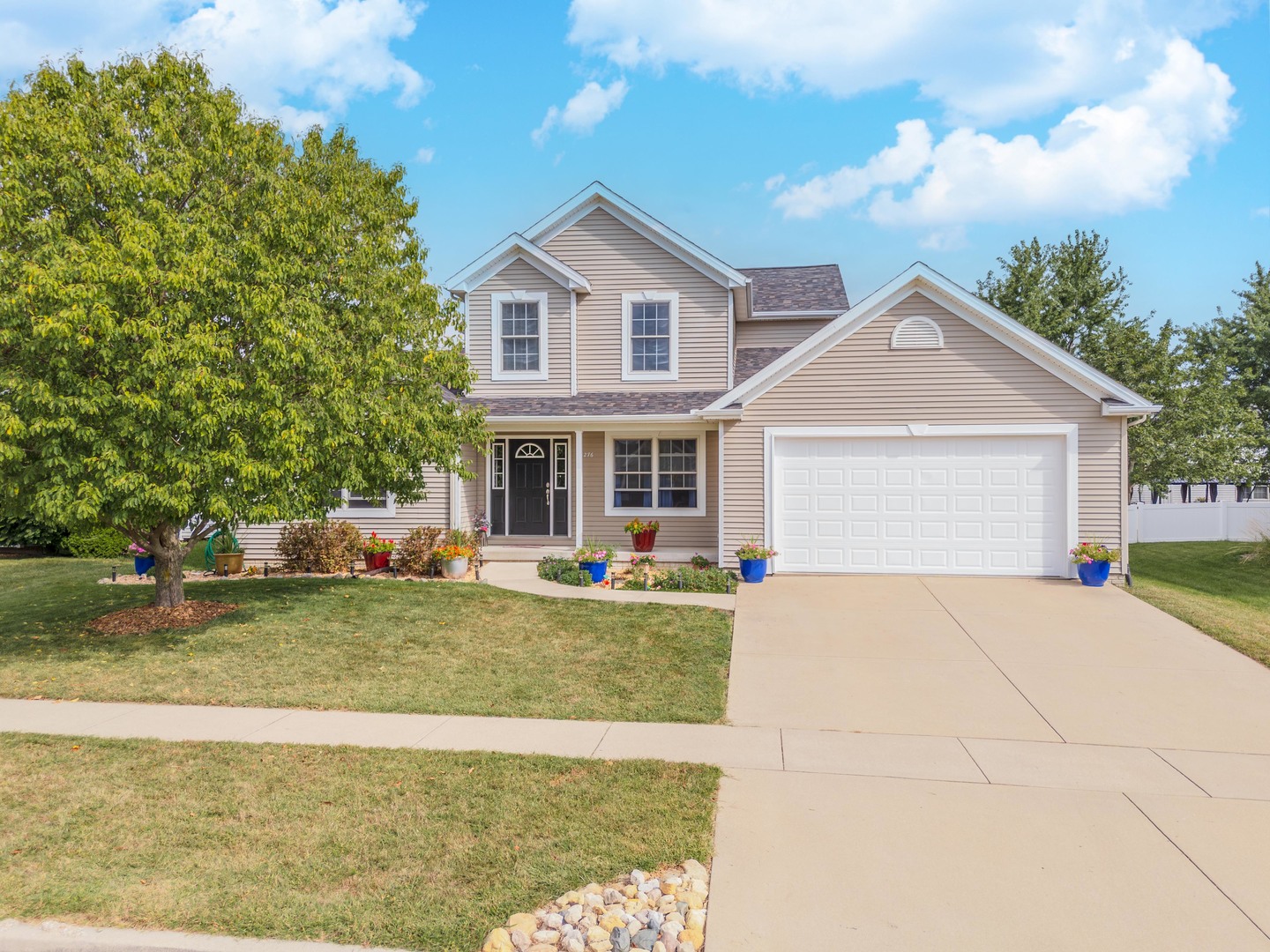 a front view of a house with swimming pool having outdoor seating