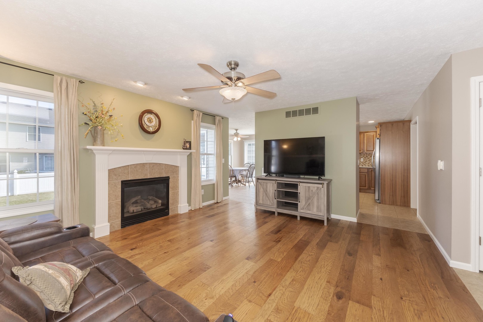 3276 Fire Fly Court Normal, IL 61761 - Photo 17 of 52 a living room with furniture a flat screen tv and a fireplace