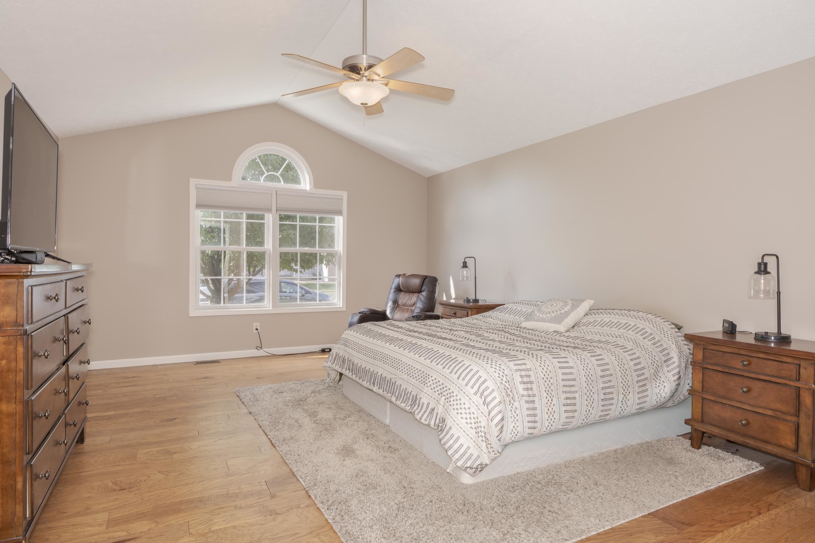 3276 Fire Fly Court Normal, IL 61761 - Photo 27 of 52 a spacious bedroom with a large bed a chandelier and windows