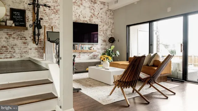 a living room with furniture a flat screen tv and a fireplace