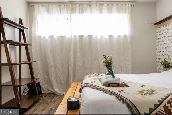 a bed sitting in a bedroom next to a window