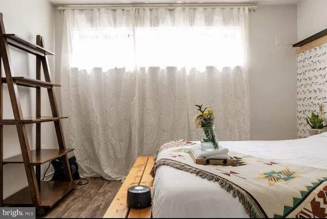 a bed sitting in a bedroom next to a window