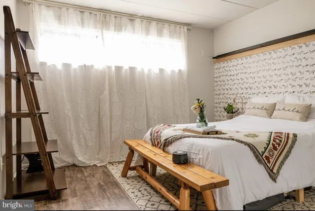 a bedroom with a bed and a potted plant