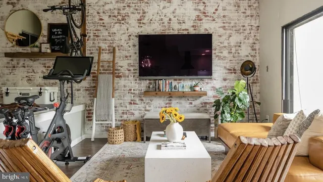 a living room with furniture a flat screen tv and a fireplace