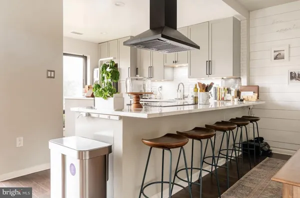 a kitchen with stainless steel appliances kitchen island granite countertop a sink and cabinets
