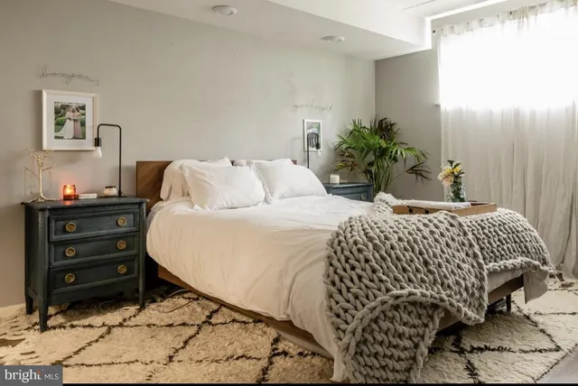 a bedroom with a bed and a dresser