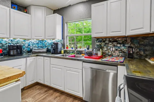 a kitchen with a sink cabinets and window