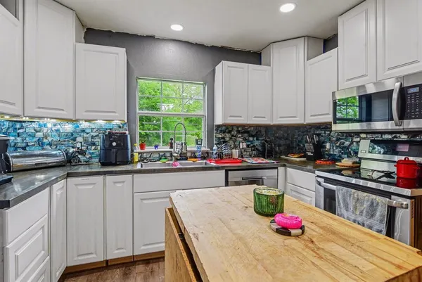 a kitchen with sink cabinets and window