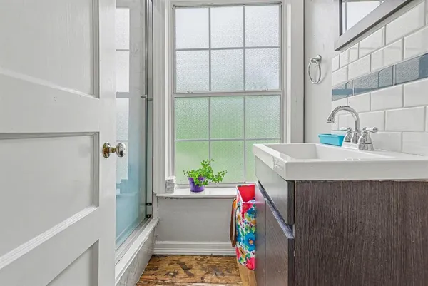 a bathroom with a sink and a shower
