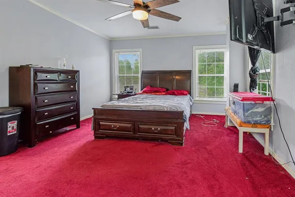 a bedroom with a bed and a window