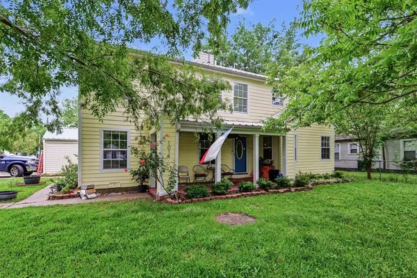 a view of a house with a yard and sitting area